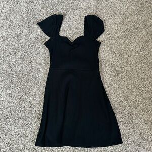 Black Ribbed at the chest area dress. Sleeves are flared